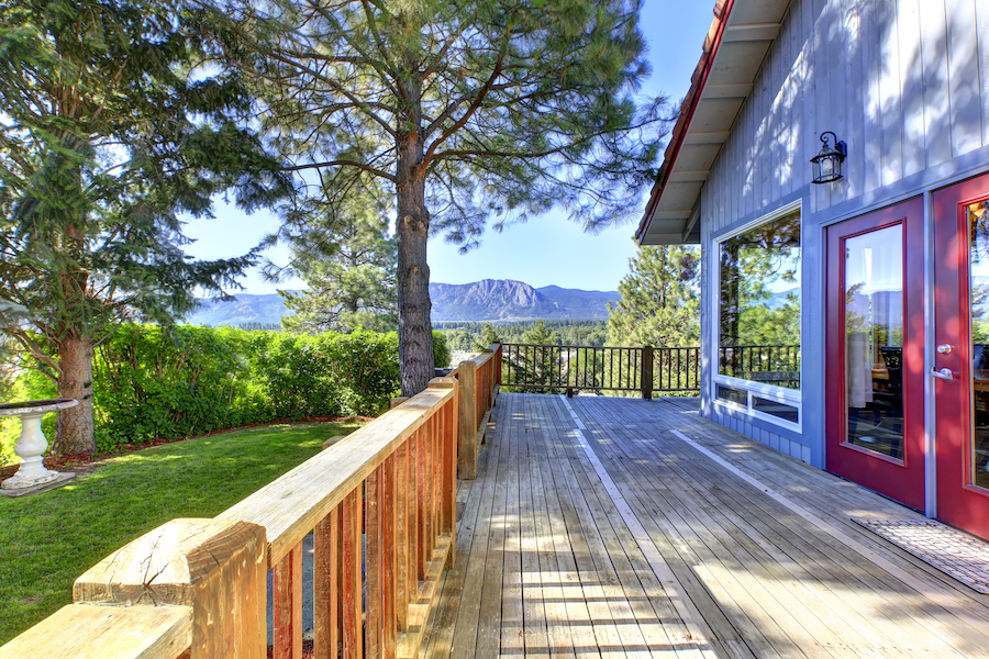 Large wooden deck of blue house 